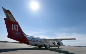 Crew Chief Matt Dauenhauer prepares to chock the BAe 146 tanker after it parked Tuesday, May 19, 2015, at BLM Alaska Fire Service tanker base at Fort Wainwright. The jet propelled tanker can carry 3,000 gal. of retardant and has a cursing speed of more than 400 miles per hour. It has the ability to rapidly move between multiple fires, dropping partial loads on each. Sam Harrel BLM-AFS photo