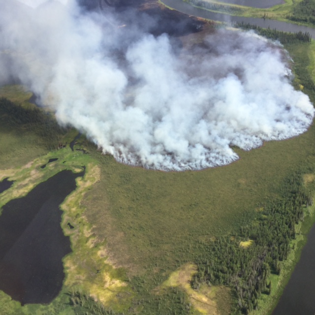 The Mauneluk River 2 fire near the Gates of the Arctic National Park and Preserve puts up smoke while burning through almost 34,000 acres and three miles on July 15, 2016. Photo by Ryan McPherson, BLM Alaska Fire Service.