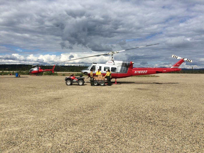 Helicopter N16920 being loaded with QB's (collapsable 5 gallon container filled with water) to be delivered to the firefighters in the field. The same helicopters will be assisting with demobing the crews.