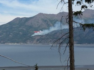An air tanker drops a load of retardant on the wildfire burning near McHugh Creek along the Seward Highway just south of Anchorage.