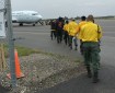 Emergency firefighter crews from Chevak, Hooper Bay, Huslia and Kaltag line up to board a jet that will take them to the Lower 48 to work on wildland fires. Photo by Darla Theisen/Alaska Division of Forestry