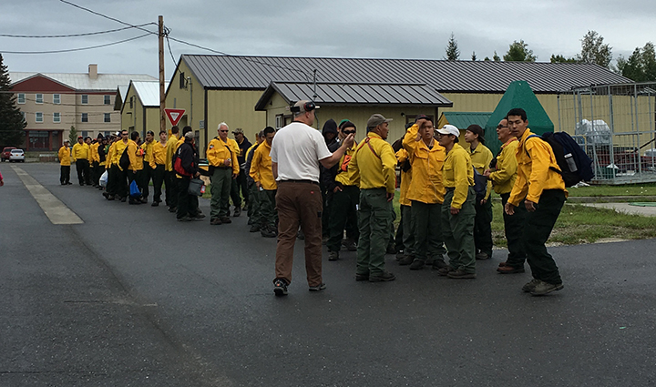 Emergency firefighter crews from Chevak, Hooper Bay, Huslia and Kaltag line up to board a jet that will take them to the Lower 48 to work on wildland fires. Photo by Darla Theisen/Alaska Division of Forestry