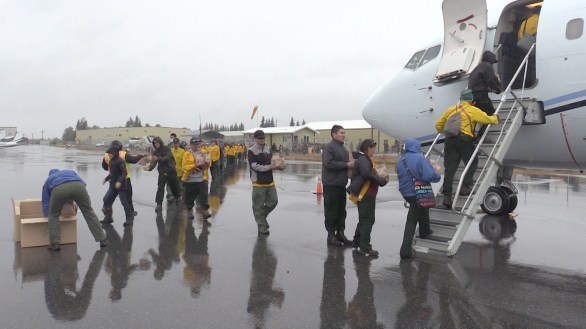Four Type 2 emergency firefighter crews board a plane bound for the Lower 48 on Aug. 5, 2018. Photo by Beth Ipsen, BLM AFS.