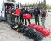 BLM Alaska Fire Service Chena Interagency Hotshots unload their gear shortly arriving at a staging area for the Oregon Lakes Fire Sunday night. The Midnight Sun and Chena Hotshots are joining the suppression efforts on the fire today. Photo by Beth Ipsen, BLM AFS