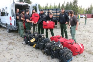 BLM Alaska Fire Service Chena Interagency Hotshots unload their gear shortly arriving at a staging area for the Oregon Lakes Fire Sunday night. The Midnight Sun and Chena Hotshots are joining the suppression efforts on the fire today. Photo by Beth Ipsen, BLM AFS