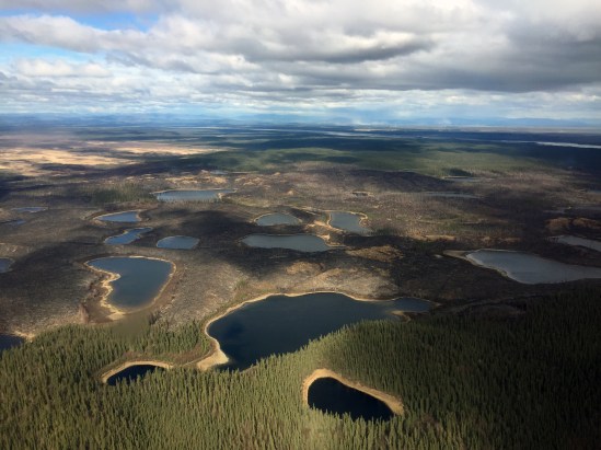 In this photo, Lakes dot the landscape where the Oregon Lakes Fire is burning on May 8, 2018. Winds kicked up dust from the Tanana River river bed near Delta Junction as seen in the far distance. Photo by Isaiah Fischer, BLM AFS