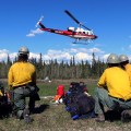 Photo of members of the Division of Forestry's Pioneer Peak Interagency Hotshot Crew wait for their turn to shuttle to the fireline on May 15, 2019.