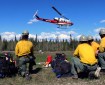 Photo of members of the Division of Forestry's Pioneer Peak Interagency Hotshot Crew wait for their turn to shuttle to the fireline on May 15, 2019.