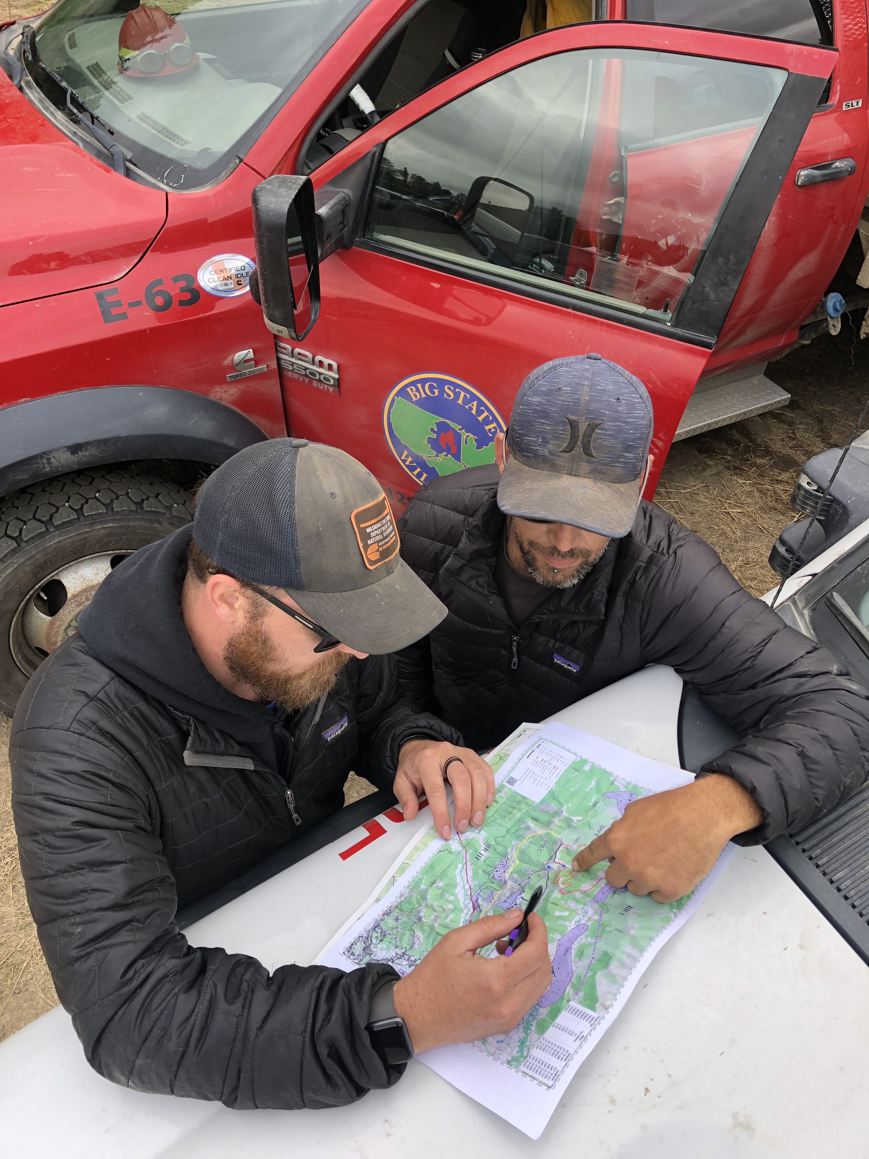Graham MaGee and Paul Valentine mapping out a plan for Big State Wildfire suppression support services to do structure protection including setting up pumps and sprinkler kits on Parch and Martin subdivisions.
