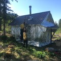 Firefighters add protection wrapping around the historic Harry Johnson cabin on the Kenai National Wildlife Refuge.