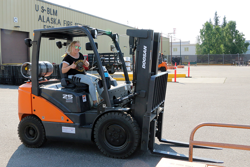Photo of Kate Barthel, a materials handler from the Rocky Mountain Fire Cache in Denver, is in Alaska helping with the workload of equipment being issued out of the BLM Alaska Fire Service Cache. The AFS Cache provides supplies and equipoment for all fire suppression and fire management operations in coordination with other statewide agencies. Photo by Beth Ipsen, BLM AFS