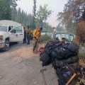 Members of the Alaska Division of Forestry's Gannett Glacier Type 2 Initial Attack Crew prepare to load their gear onto a jetboat to be transported across the Klutina River to the Klutina River Fire on Wednesday, July 10, 2019. Photo by Danny Schmitz