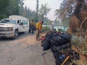 Members of the Alaska Division of Forestry's Gannett Glacier Type 2 Initial Attack Crew prepare to load their gear onto a jetboat to be transported across the Klutina River to the Klutina River Fire on Wednesday, July 10, 2019. Photo by Danny Schmitz