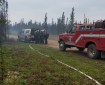 A brush truck from the Anderson Volunteer Fire Department is parked along Kobe Ag Road near the Kobe Fire on Friday morning, July 12, 2019 as members of the White Mountain Type 2 Initial Attack Crew gear up to head to the fire after arriving Friday morning. Photo by Chief Scott Thompson/Anderson Volunteer Fire Department