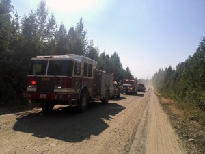 Emergency vehicles from the Matanuska-Susitna Borough are staged along Montana Creek Road to assist with structure protection on the Malaspina Fire on Sunday, July 7,2019. Photo by Brentwood Reid/Alaska Division of Forestry