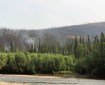 Light smoke from the Nugget Creek Fire burning in the Chena River State Recreation Area rises near the Chena River along Chena Hot Springs Road on Tuesday, July 2, 2019. Photo by Meg Cicciarella/Alaska Division of Forestry