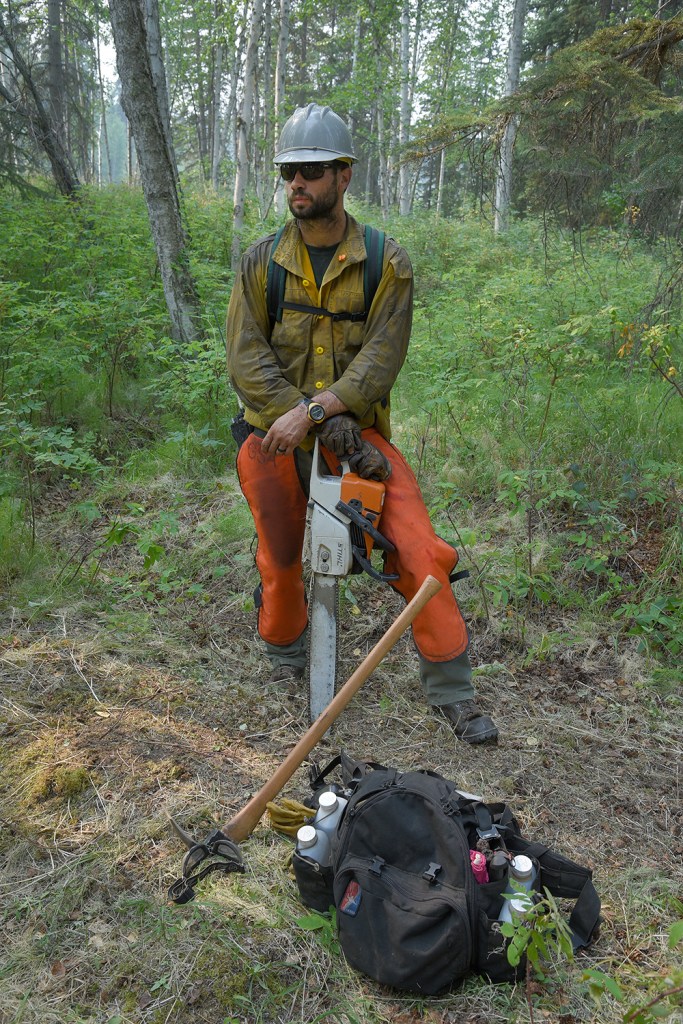 Grangeville, Idaho, Smokejumper Lee Trap takes a break from saw work as he and three other smokejumpers work on site protection along the Little Black River on Wednesday, July 17, 2019. Sam Harrel/Alaska Interagency Incident Management Team