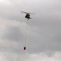 A Blackhawk helicopter from the Alaska Army National Guard hauls a bucket of water to drop on the Rainbow 2 Fire on Tuesday, July 16, 2019. Photo by Mike Goyette/Alaska Division of Forestry