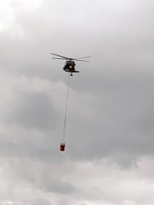 A Blackhawk helicopter from the Alaska Army National Guard hauls a bucket of water to drop on the Rainbow 2 Fire on Tuesday, July 16, 2019. Photo by Mike Goyette/Alaska Division of Forestry