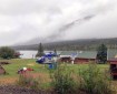 A helicopter contracted by the Alaska Division of Forestry sits near Rainy Pass Lodge on Wednesday morning, July 24, 2019 as smoke from the Rainy Pass Fire a mile away is visible. Photo by Greg King/Soloy Helicopters