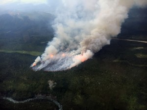 The Rainy Pass Fire (#662) as seen from the air Tuesday night during the initial attack response. The Rainy Pass airstrip is visible in the background about one-half mile away. Photo by Alaska Division of Forestry Air Attack