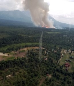 The smoke column from the Rainy Pass Fire (#664) rises about one-half mile from Rainy Pass Lodge on Tuesday night, July 23, 2019. Photo by Alaska Division of Forestry Air Attack