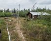 Sprinkler and hose line around a remote cabin in the Upper Yukon Zone.