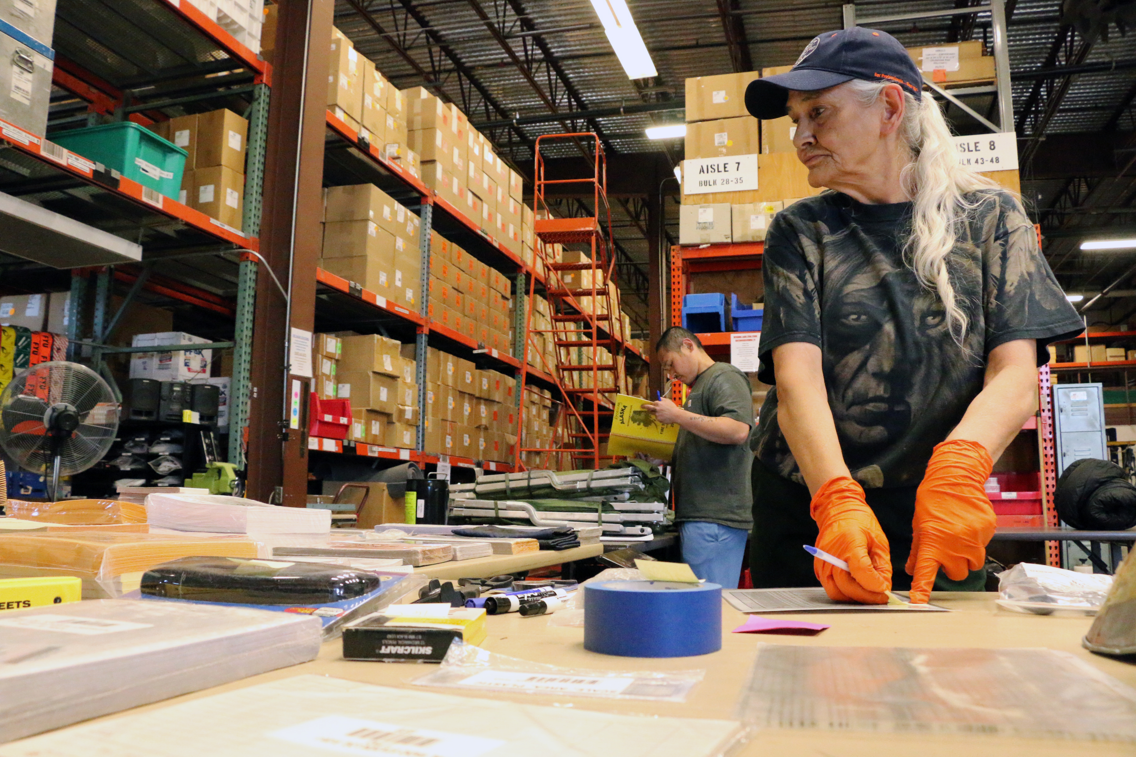 BLM AFS Materials Handler Betty Itta, in front, and Kevin Voravong catalog on June 3, 2019 equipment that is turned back in to be refurbished and available for reuse