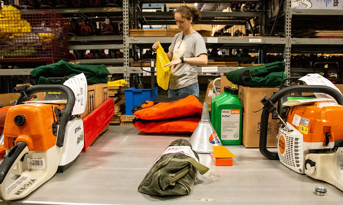 Materials Handler Melissa Davis puts together a chainsaw kit that will go out to a fire on June 3, 2019.