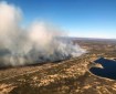 Smoke from a wildfire burning in tundra grass near Pilot Point, Alaska