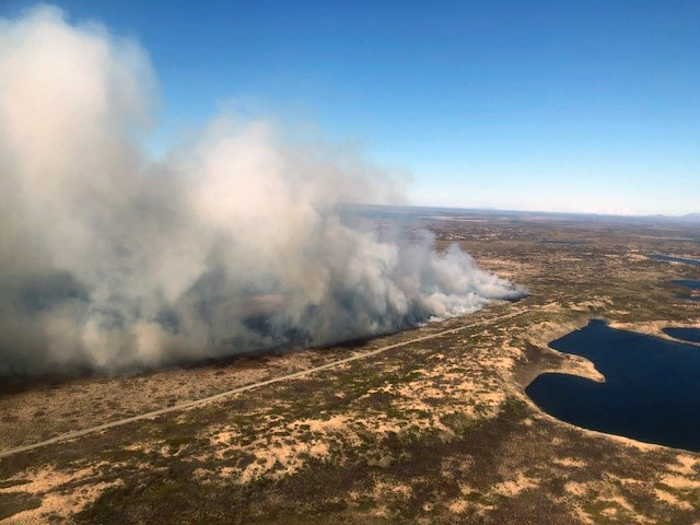 Smoke from a wildfire burning in tundra grass near Pilot Point, Alaska
