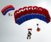 Two people wearing oversized yellow suits floating in the air underneath red, white and blue parachutes.