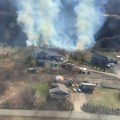 Air Attack monitors Olia Port Fire burning in dry grass and brush in Homer, Alaska.