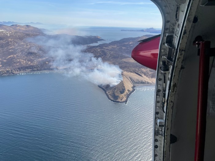 This aerial photograph shows smoke rising from the Danger Point Fire burning along the coast of Popof Island, Alaska