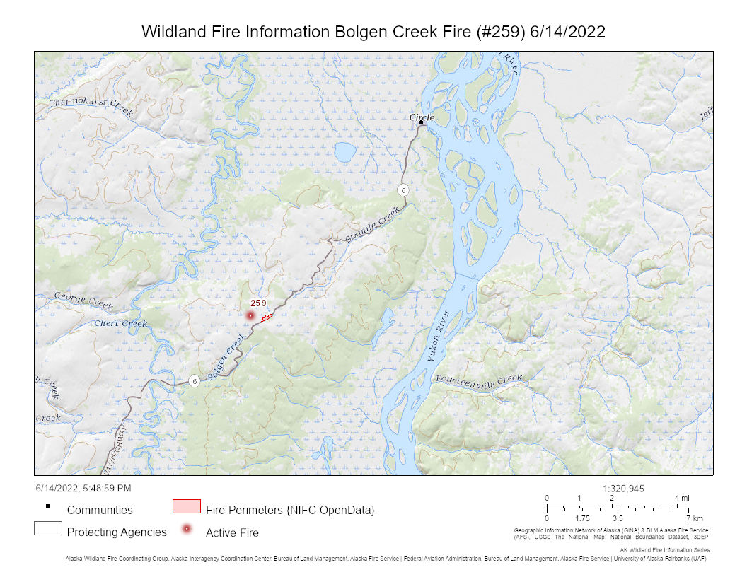 A map with a red dot showing a fire next to a road leading to a town.