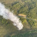aerial view of a forest fire adjacent to a road