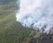 Smoke visible from the reconnaissance flight about Fly Over reconnaissance flight above the Aghaluk Mountain Fire (#206). Isolated tree torching can also be seen in the black spruce.