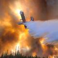 A large aircraft drops water on a fire while the sky is awash with red smoke.