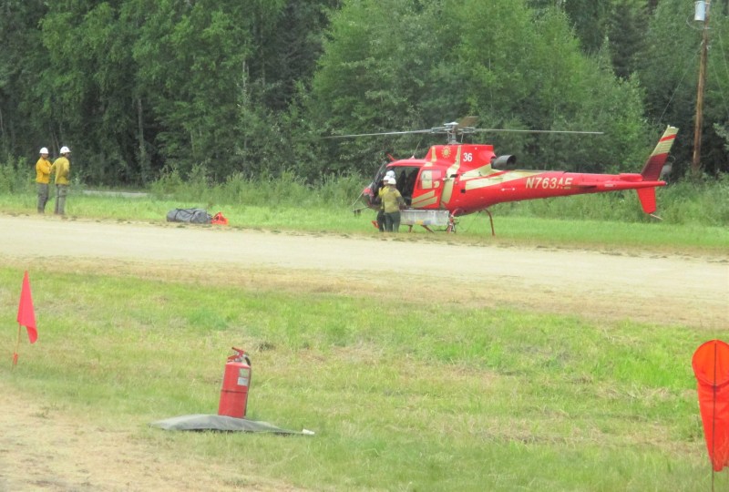 Incident helicopter and firefighters located on the ground at the Manley Hot Springs airstrip