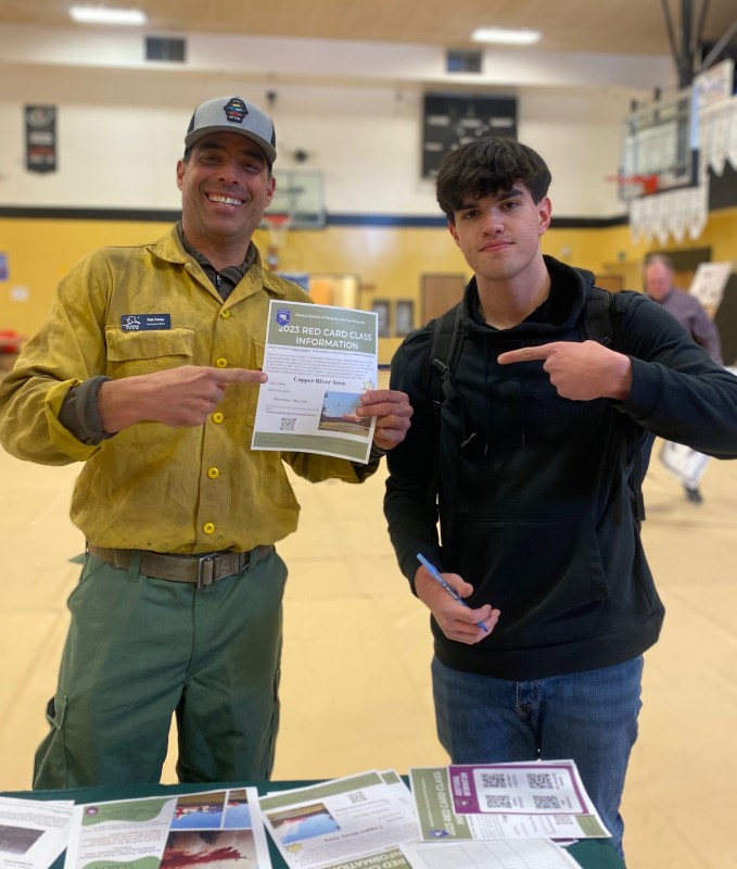 DOF Public Information Officer with a prospective new firefighter at Glennallen's Copper River Native Association Job Fair.