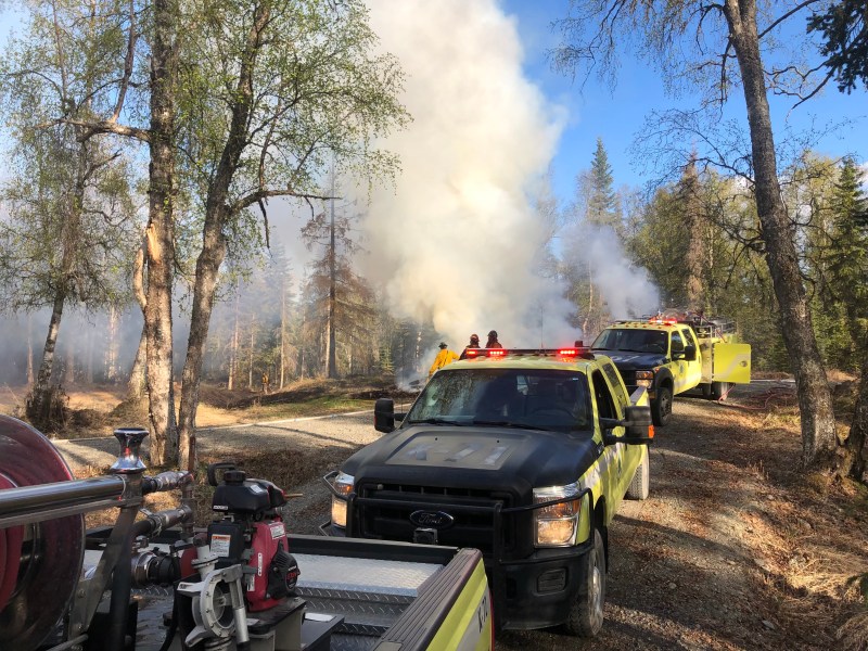 Three Division of Forestry & Fire Protection engines responding to the Charland Fire. They are parked near firefighters, providing water for suppression actions.