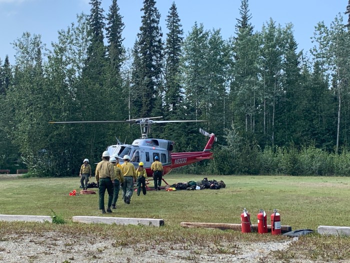 A crew loads a helicopter to be dropped in spike camp.