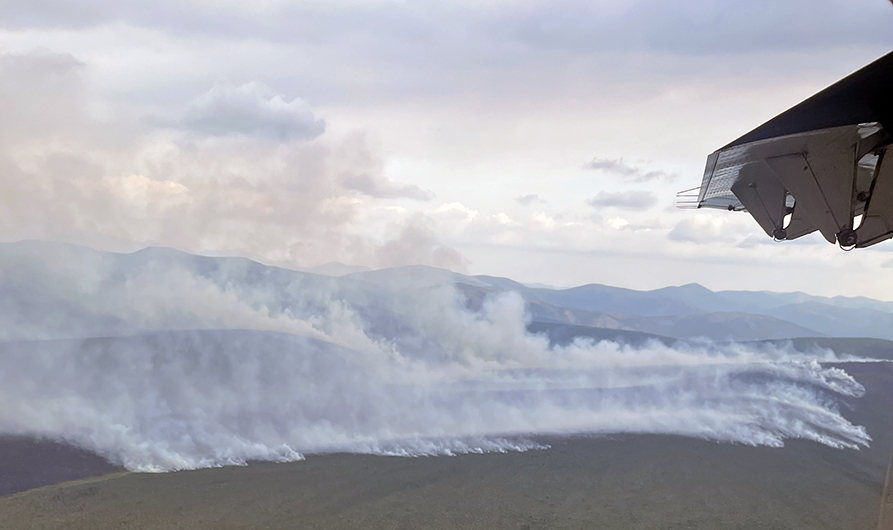 Aerial photo of smoke drifting up from the tundra.