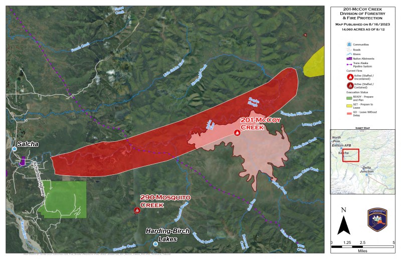 Photo of smoldering fire in upper third with river in lower third. Taken from a helicopter.