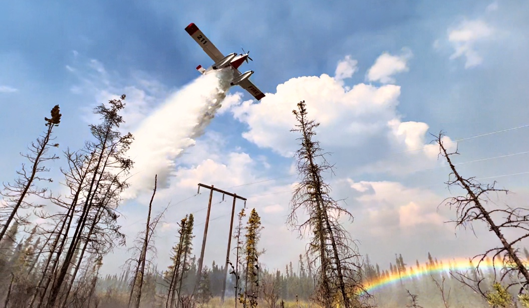 A Fire Boss drops water while protecting power lines on the Pogo Mine Road Fire (#191).
