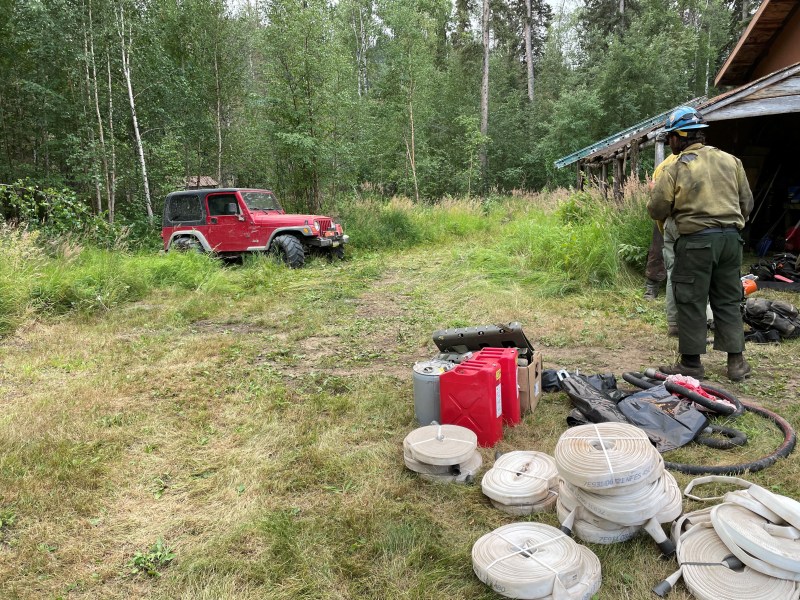 A member of the Shasta Lake Hotshots sorts structure protection equipment near the Birch Creek Fire