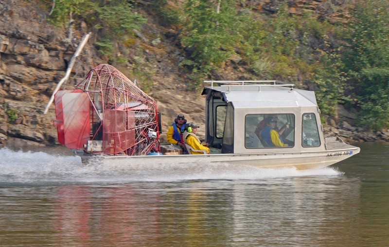 Boat carrying firefighters traveling up river.