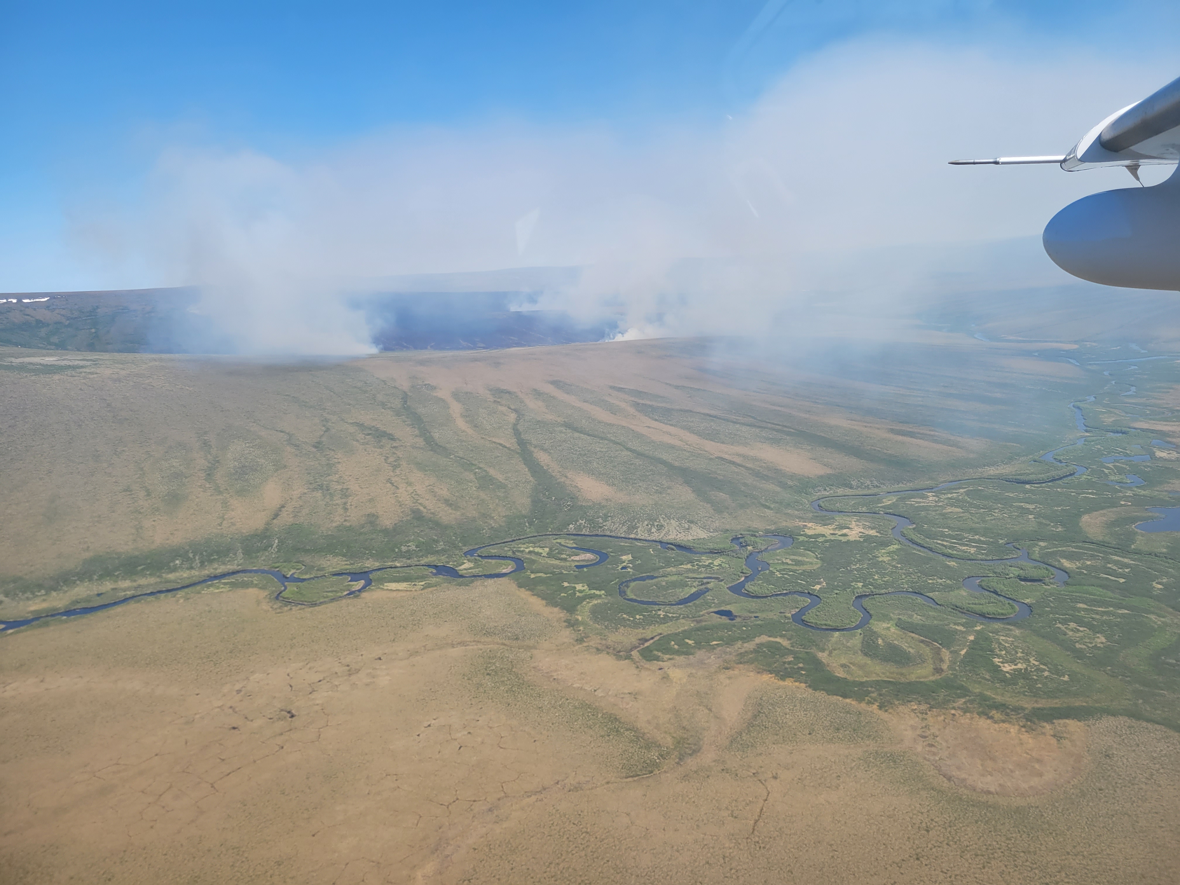 An aerial photo taken showing smoke burning from a large tundra fire.