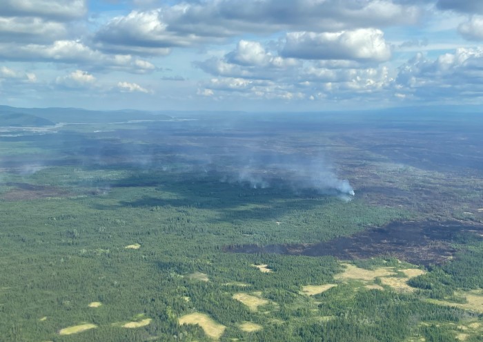 aerial view of small amounts of smokedrifting up from a forest fire