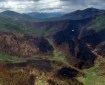 Burned forest on mountainsides.